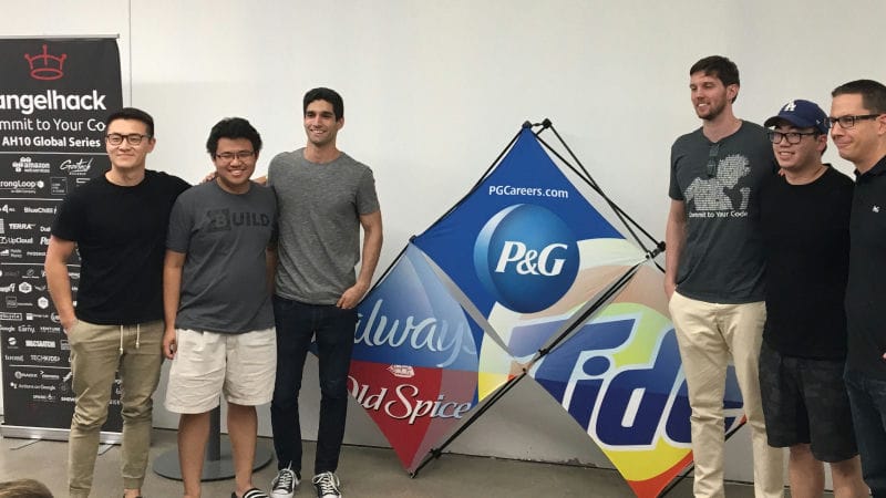 Six people posing for the camera with P&G logo in blue in the background.